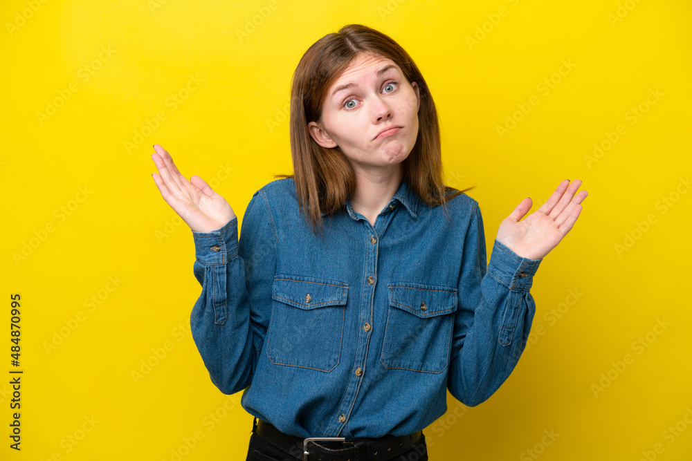 Young English woman isolated on yellow background making doubts gesture Young English woman isolated on yellow background making doubts gesture