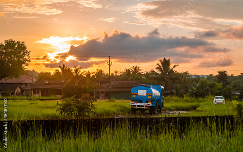 Wallpaper Mural Fuel tanker standing on soil made village road with beautiful sunset scene in Indian village Torontodigital.ca