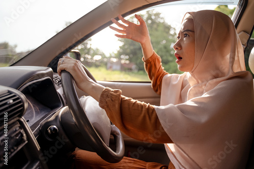 Wallpaper Mural frustrated young muslim woman while driving her car Torontodigital.ca