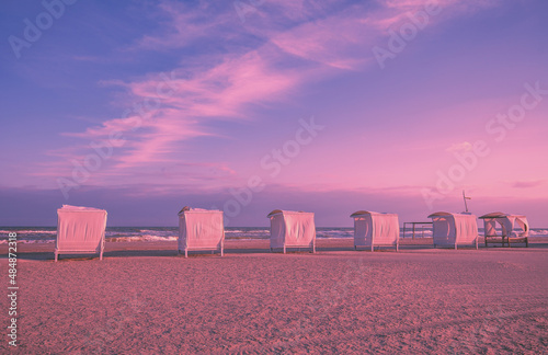 Fototapeta Naklejka Na Ścianę i Meble -  Seascape in the evening. Wooden sun gazebos on the beach
