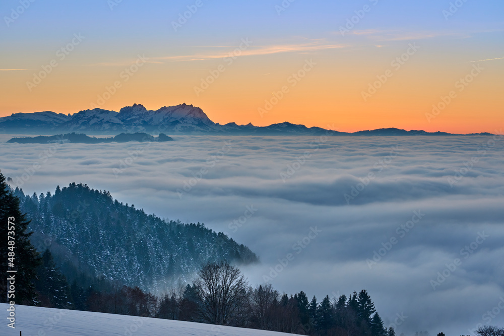 sunset in the snowy Bregenzer Wald area of Vorarlberg, Austria with spectacular view on Mount Saentis above a sea of fog, Switzerland, Sulzberg, Austria, landscape