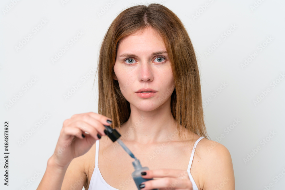 Young English woman holding a serum. Close up portrait Young English woman holding a serum. Close up portrait