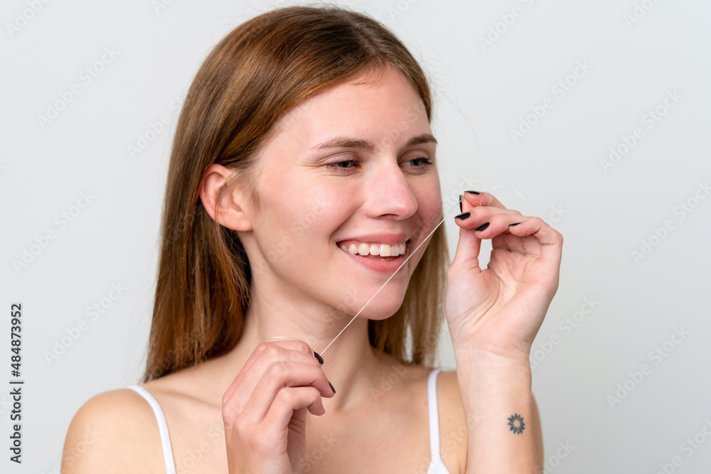 Young English woman with dental floss. Close up portrait