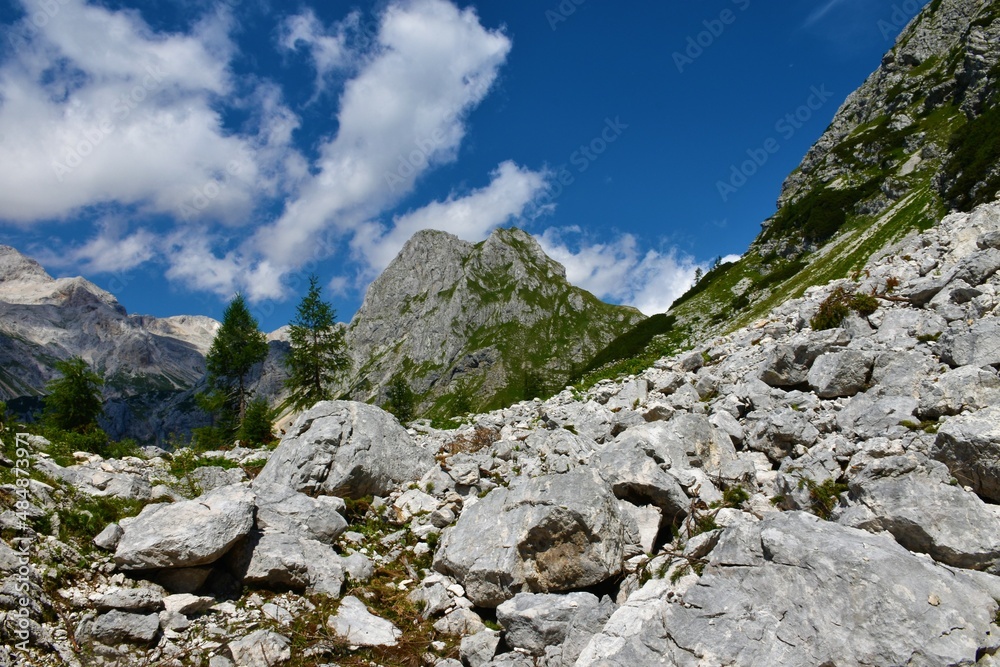 View of mountain Vernar in Julian alps and Triglav national park, Slovenia with large rocks covering the slope in front View of mountain Vernar in Julian alps and Triglav national park, Slovenia with large rocks covering the slope in front