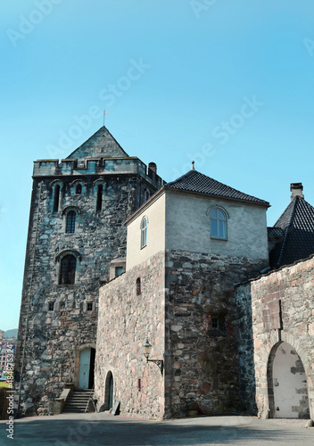 View of the tower and walls of the Bergenhus fortress in Bergen on a clear sunny day, Norway. Travel landscape sights of Europe.
