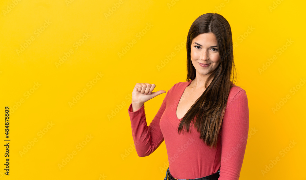 Teenager Brazilian girl over isolated yellow background proud and self-satisfied Teenager Brazilian girl over isolated yellow background proud and self-satisfied