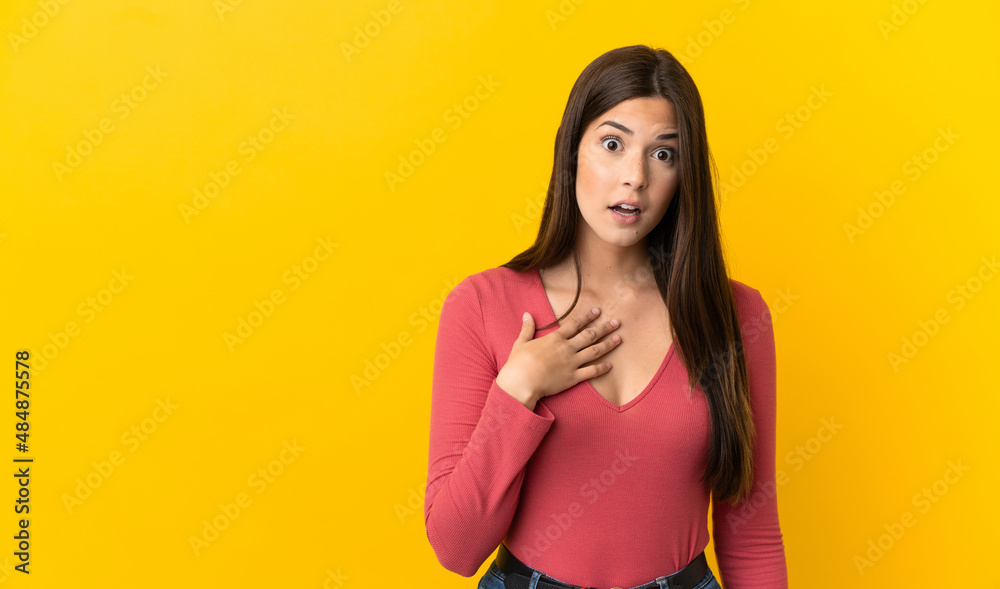 Teenager Brazilian girl over isolated yellow background pointing to oneself Teenager Brazilian girl over isolated yellow background pointing to oneself