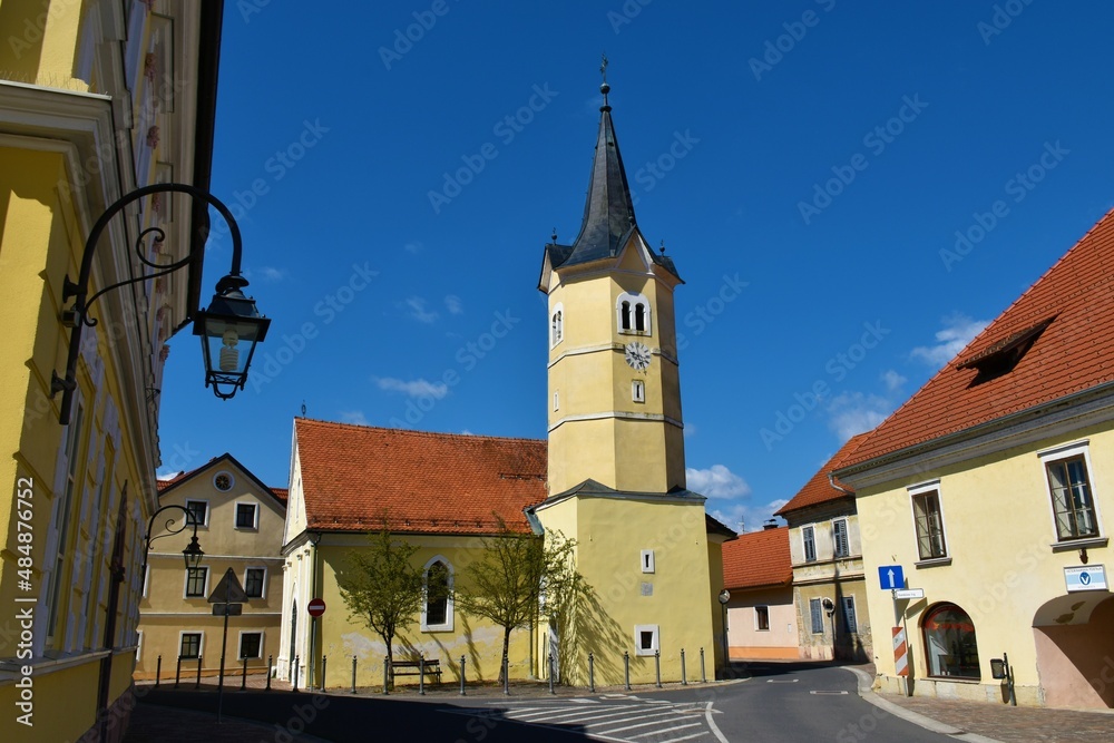 Fototapeta premium View of catholic church with a yellow facade at Kostanjevica na Krki in Dolenjska, Slovenia