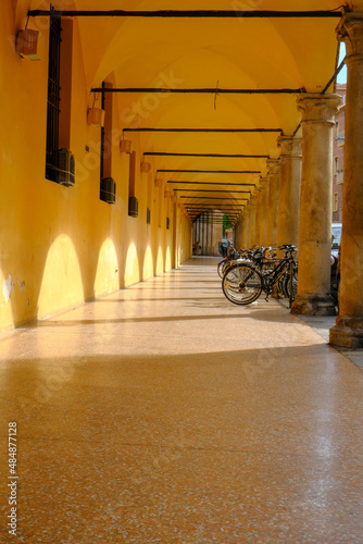 Bologna, Italy: One of the galleries in the old town of the city. Light and shadows across the gallery