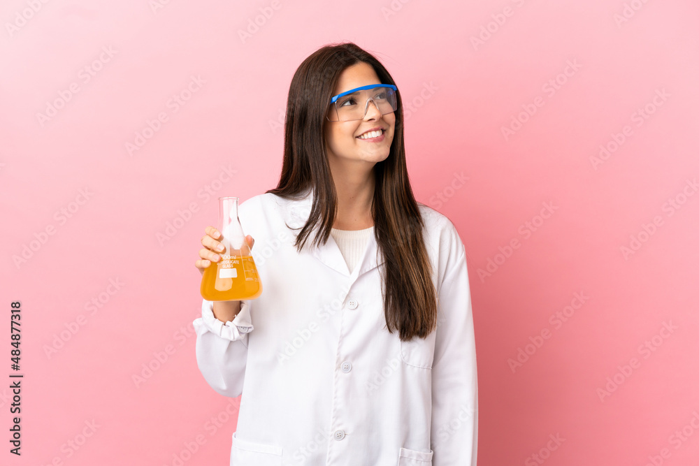 Young scientific girl over isolated pink background thinking an idea while looking up Young scientific girl over isolated pink background thinking an idea while looking up