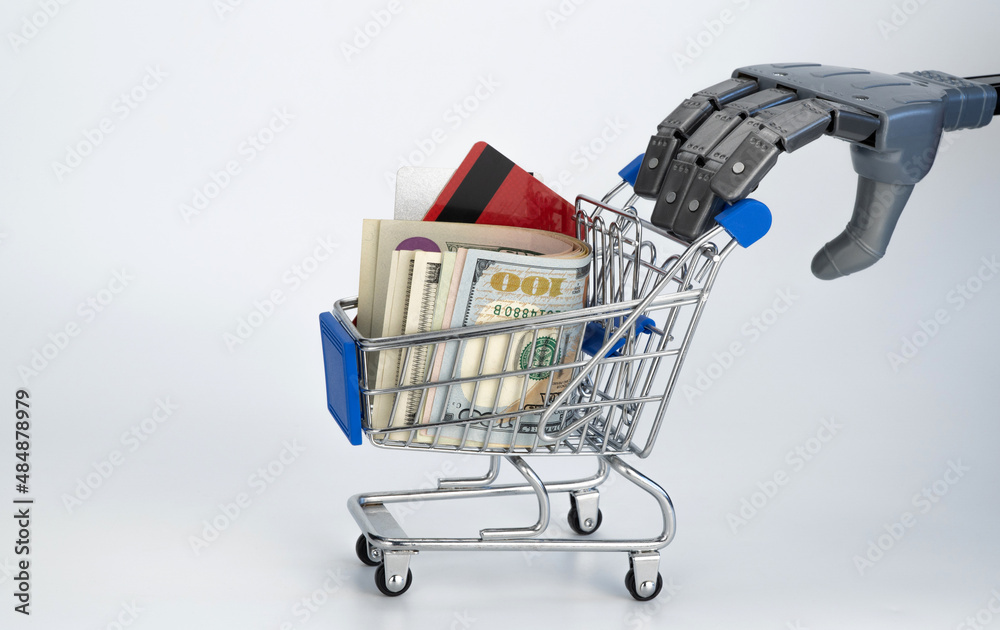 robot arm pushes a supermarket cart. white background, free space. technology future, artificial intelligence in trade and service. grocery basket with money and discount cards. contactless purchases