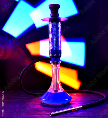 hookah with ice and neon light on black background