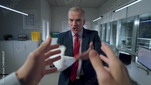 POV shot of employee being yelled by angry mature boss in office