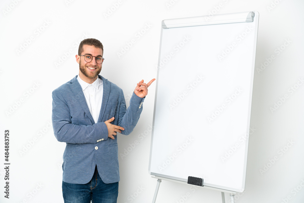 Young business woman giving a presentation on white board isolated on white background pointing finger to the side Young business woman giving a presentation on white board isolated on white background pointing finger to the side
