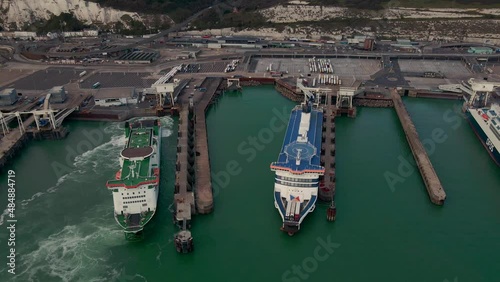 Aerial view of the Dover harbor with many ferries and cruise ships entering and exiting the port