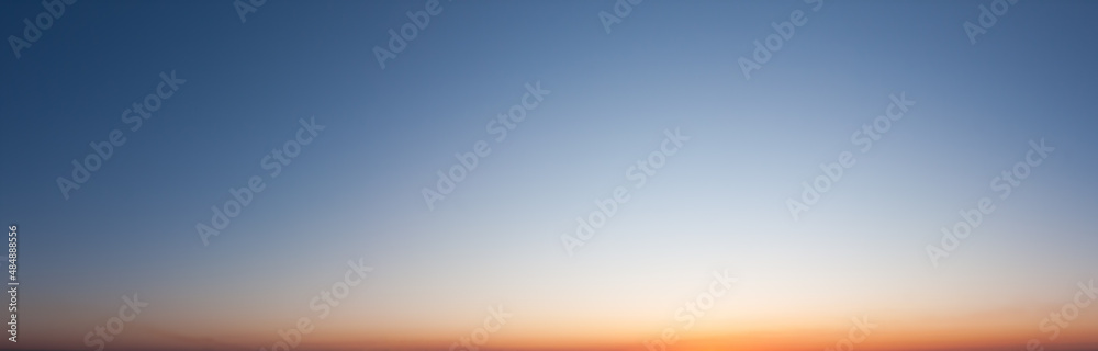 Clear blue sky in evening with bright sunset panorama