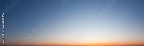 Clear blue sky in evening with bright sunset panorama