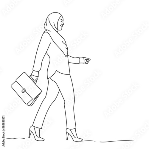 Arab business woman with a briefcase is walking.
