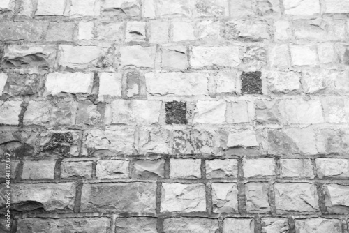 Black and white panorama stone wall for background design. Masonry from natural stone wall textured for a poster, calendar, screensaver, wallpaper, postcard, banner, cover, website