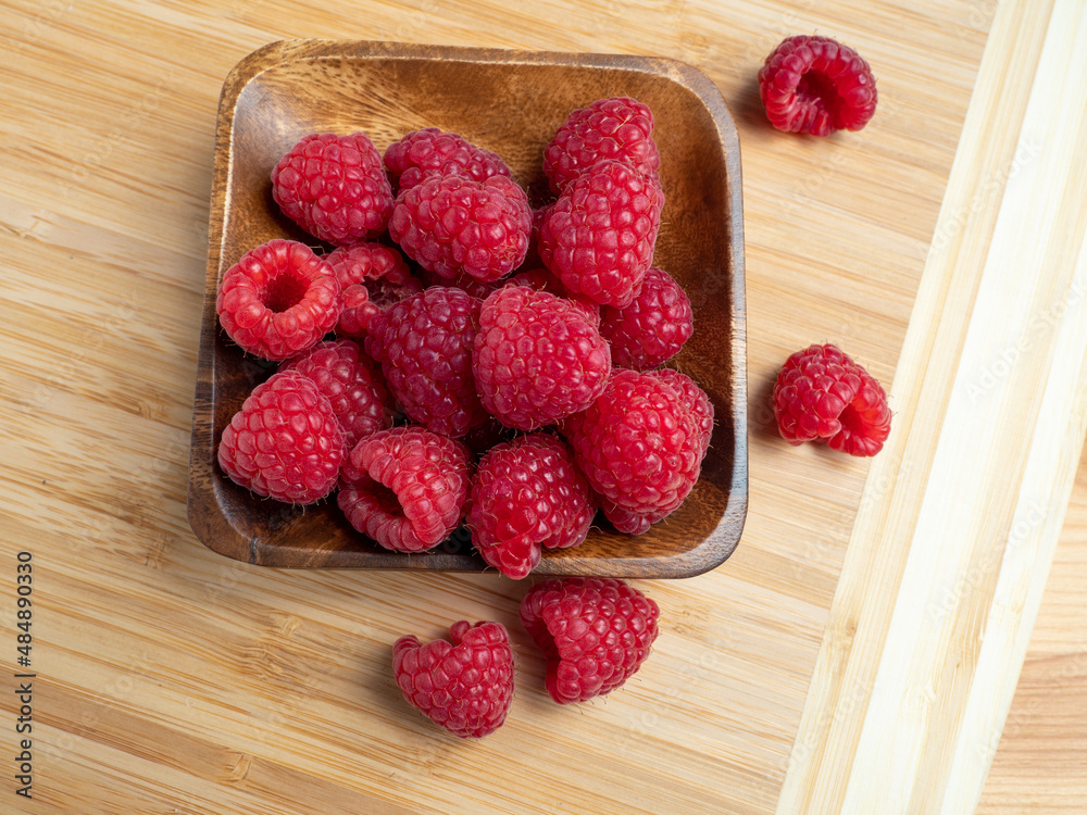 Raspberries in a wooden bowl. Raspberries in a wooden bowl.