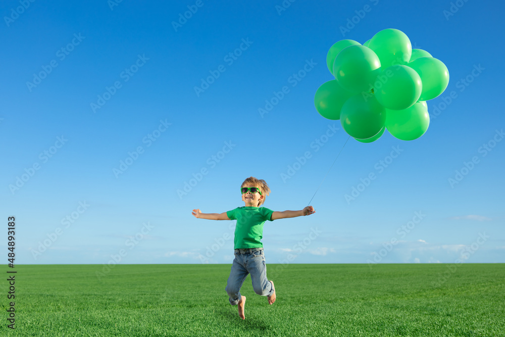 Happy child playing outdoors in spring field Happy child playing outdoors in spring field