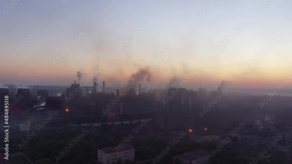 Smoke and soot from blast furnaces. Aerial view in the early morning. Harmful production and air pollution Smoke and soot from blast furnaces. Aerial view in the early morning. Harmful production and air pollution