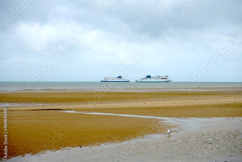 two car ferries meet on the english channel between Dover and Calais seen from the beach