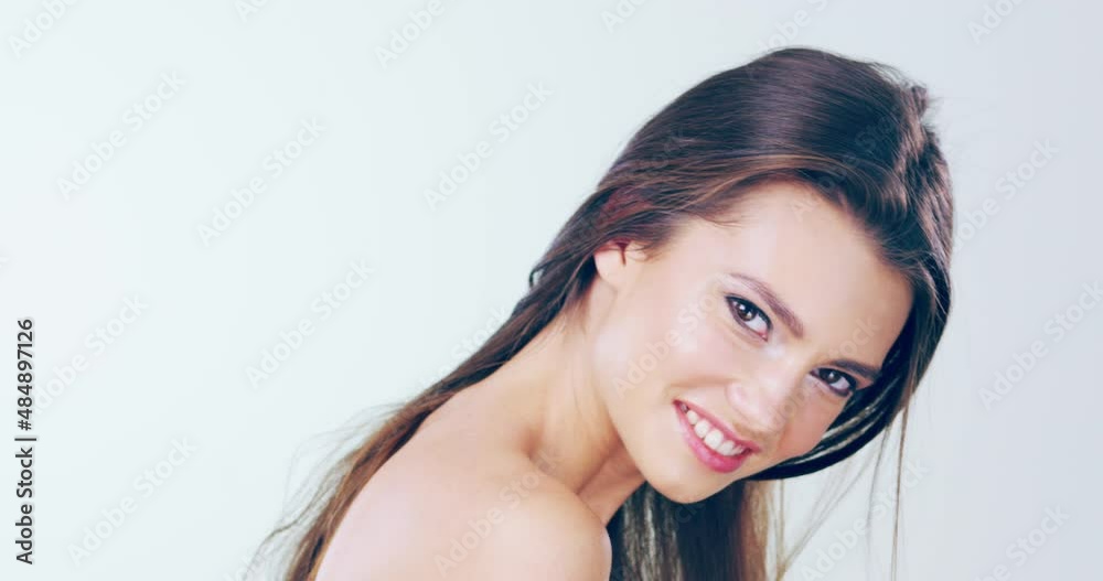 Beautiful hair makes them all stop and stare. Head shot of a beautiful young woman flipping her hair in the studio. Millennial woman tossing her healthy, long hair Beautiful hair makes them all stop and stare. Head shot of a beautiful young woman flipping her hair in the studio. Millennial woman tossing her healthy, long hair