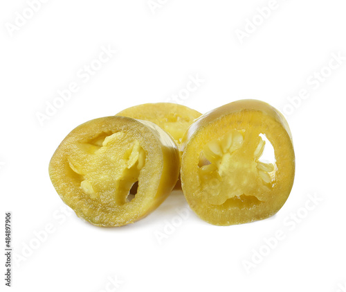 Slices of pickled green jalapeno on white background