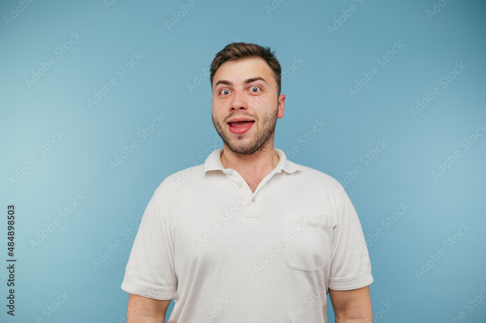 Funny stupid man with bristles isolated on blue background, looks at the camera and laughs. Funny stupid man with bristles isolated on blue background, looks at the camera and laughs.