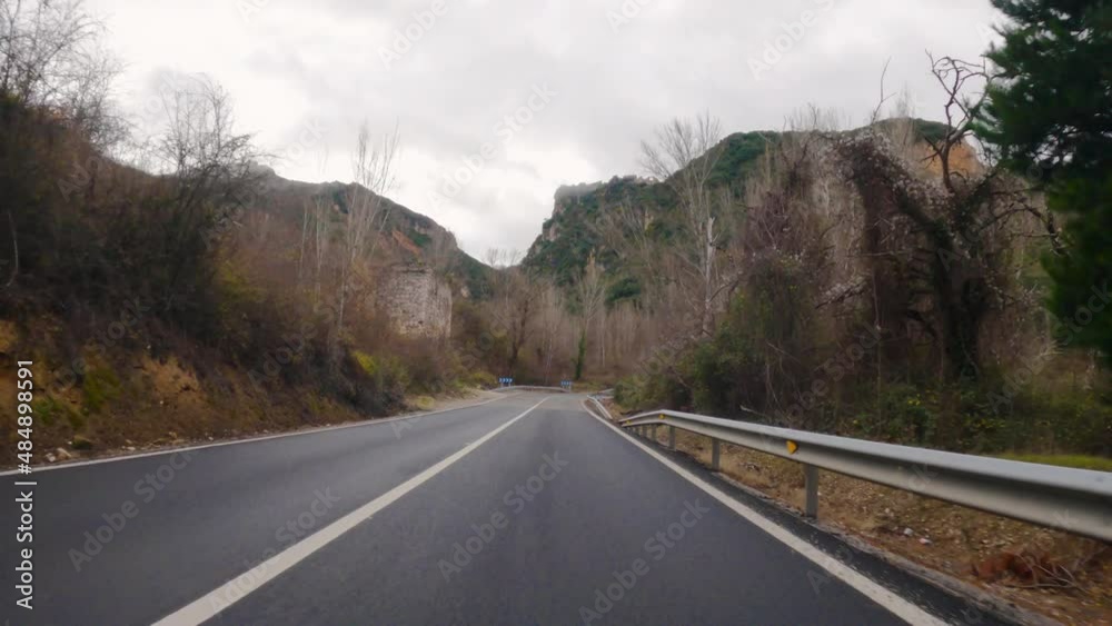 4k video of the subjective camera of a vehicle driving through the mountain roads of El Bierzo in autumn and ascending towards the castle of El Cornatel and the asphalt wet from rain and a cloudy sky 4k video of the subjective camera of a vehicle driving through the mountain roads of El Bierzo in autumn and ascending towards the castle of El Cornatel and the asphalt wet from rain and a cloudy sky