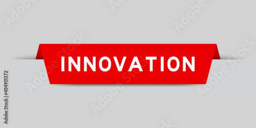 Red color inserted label with word innovation on gray background