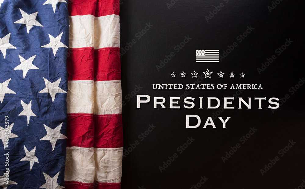 Fototapeta premium Happy presidents day concept with flag of the United States and the text on dark background.
