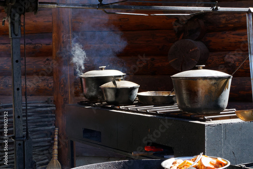 mobile open-air kitchen, food is cooked and steamed in pots and cauldrons