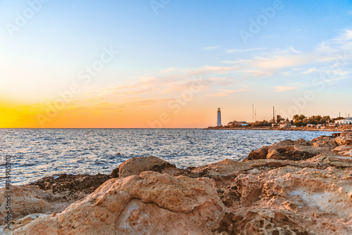 A wonderful sunset landscape on the seashore with a lighthouse on Cape Chersonesos in the Crimea