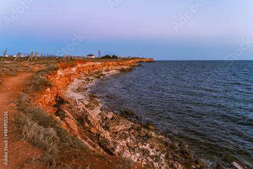 Orange rocks of the seashore at the Cape of Chersonesos in the Crimea at sunset