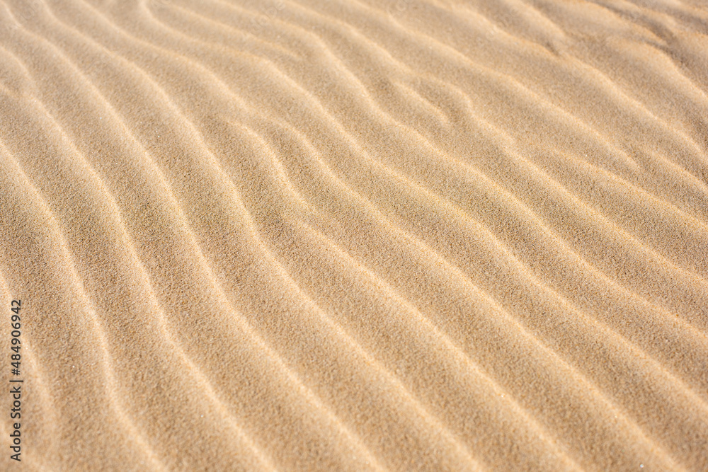 Diagonal ripples in a yellow sand natural textured background. Diagonal ripples in a yellow sand natural textured background.