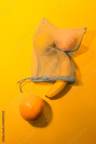  Fruits in a disposable bag on a yellow background. High quality photo