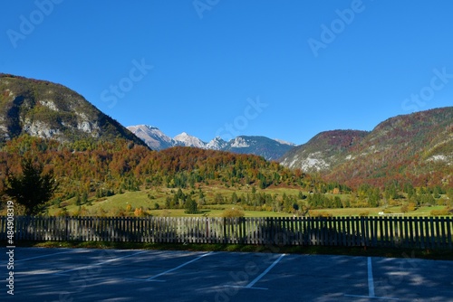 View of mountain peak Tosc, Ablanca and Draski Vrh in Julian alps and Triglav national park, Slovenia in autumn and a parking lot in front photo