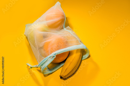  Fruits in a disposable bag on a yellow background. High quality photo