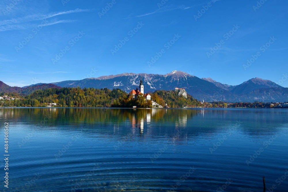 Scenic view of lake Bled and the church of the assumption of Mary on an island in Slovenia with a reflection in the water