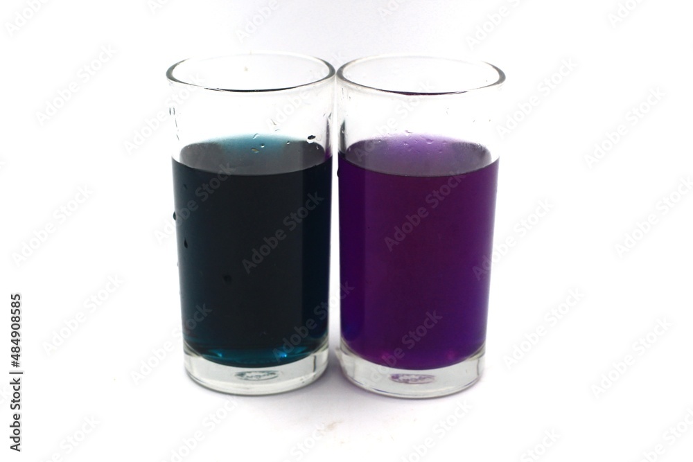 glass of purple water on a white background glass of purple water on a white background