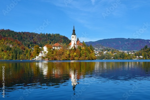 Church of the Assumption of Mary on an island in Bled lake in Gorenjska, Slovenia in autumn and a reflection of thechurch in the water © kato08