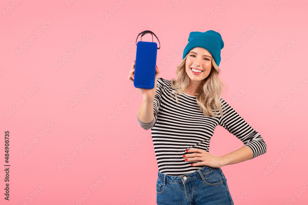 young woman holding music speaker young woman holding music speaker