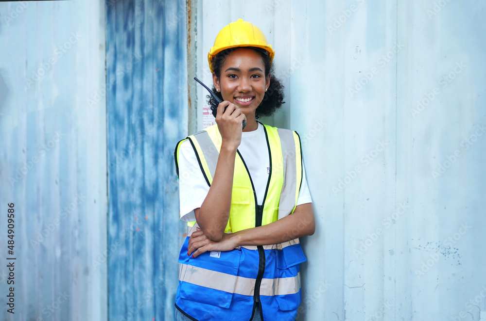 Female Foreman checking and control loading containers box in import-export area from Cargo freight ship. Female Foreman checking and control loading containers box in import-export area from Cargo freight ship.