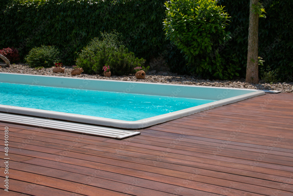 Swimming pool with teakwood flooring stripes summertime leisure ideas