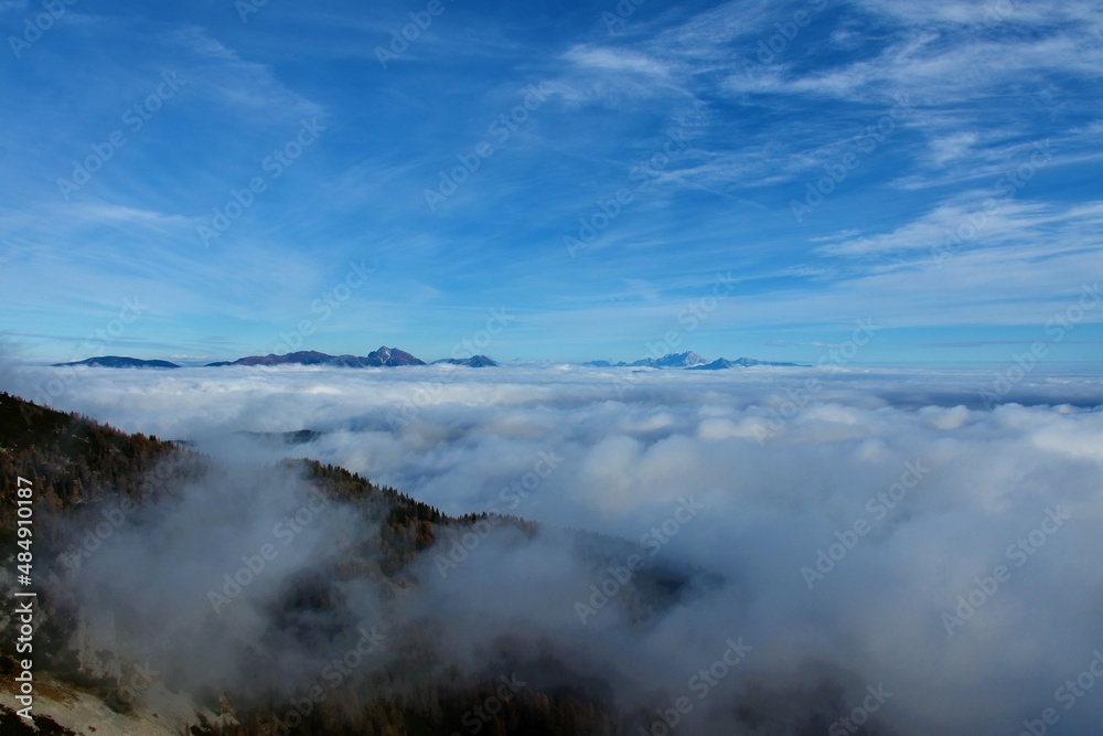 Scenic view of Karavanke and Kamnik-Savinja alps in Gorenjska, Slovenia rising above the clouds