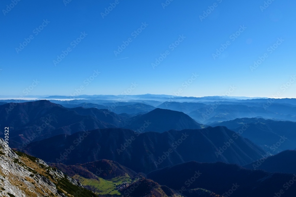 View of hills of pre-alpine Slovenia with Sneznik mountain behind