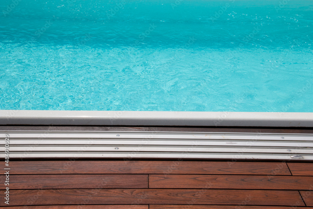 Horizontal lines of wood and edging pool enclosure aluminum tracks in detail
