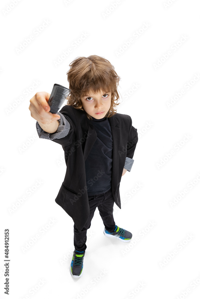 Portrait of liitle boy, kid in image of stylish hairdresser, barber isolated on white studio background. Concept of occupation, modern specialists, childhood Portrait of liitle boy, kid in image of stylish hairdresser, barber isolated on white studio background. Concept of occupation, modern specialists, childhood